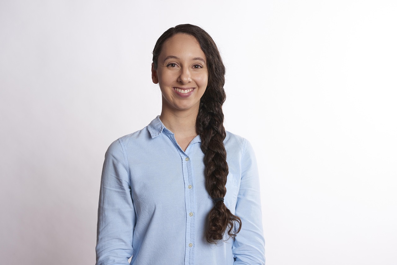 Friendly professional insurance advisor smiling in a bright office