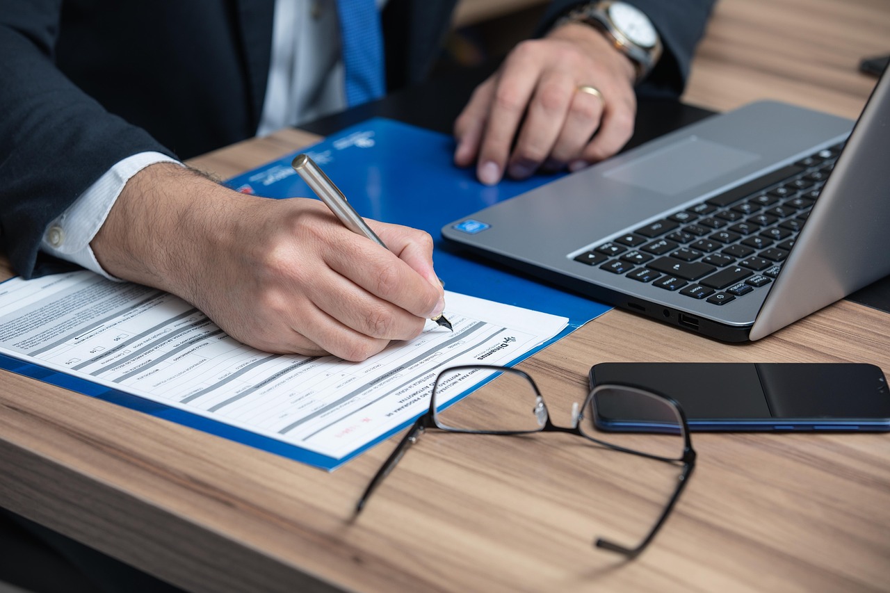 Lawyer in a suit reviewing and signing a legal real estate contract at a desk