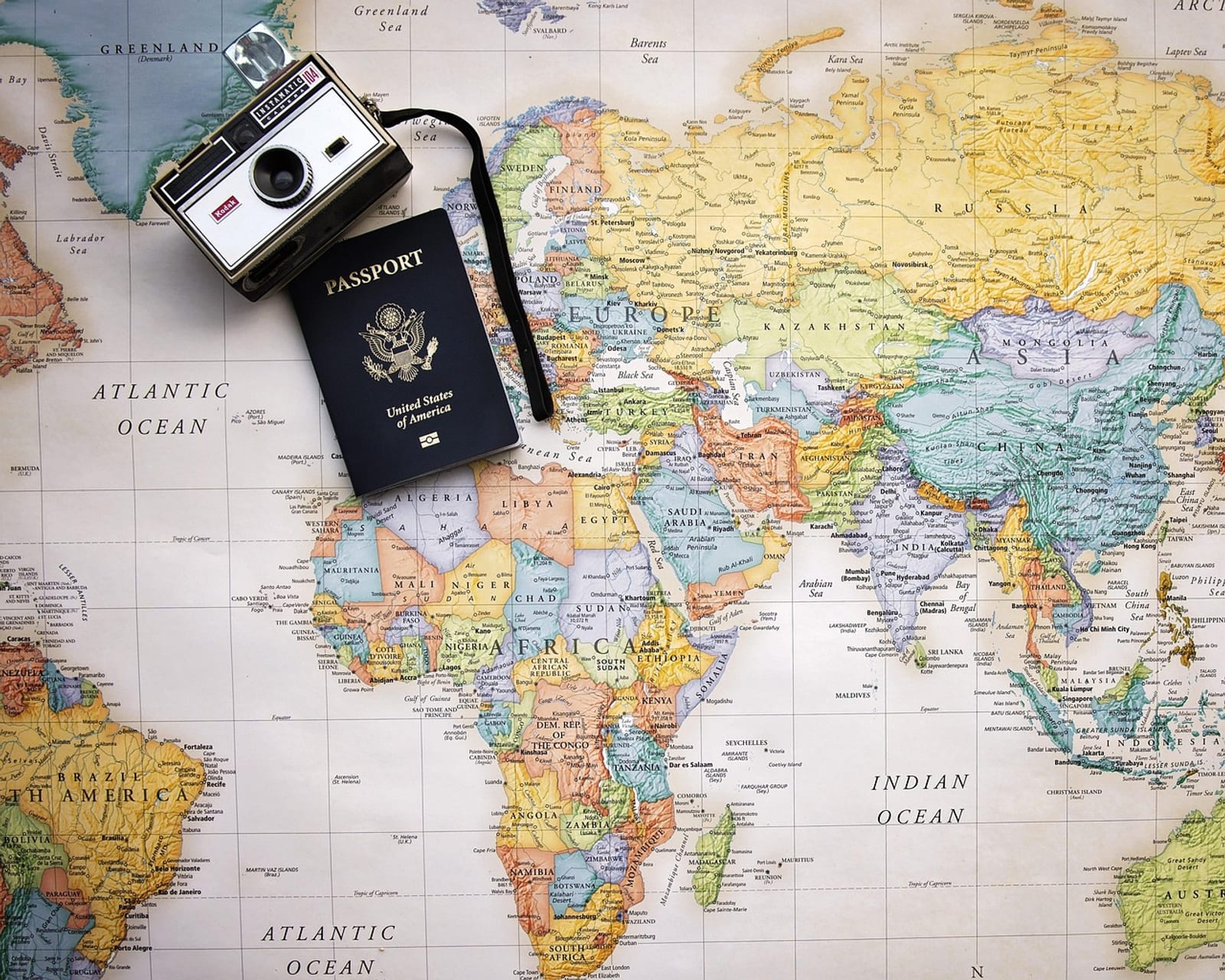 World map with a passport and city skyline